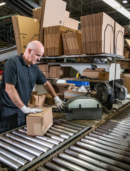 Image of a Merit Brass team member collecting product to fulfill a customer's order